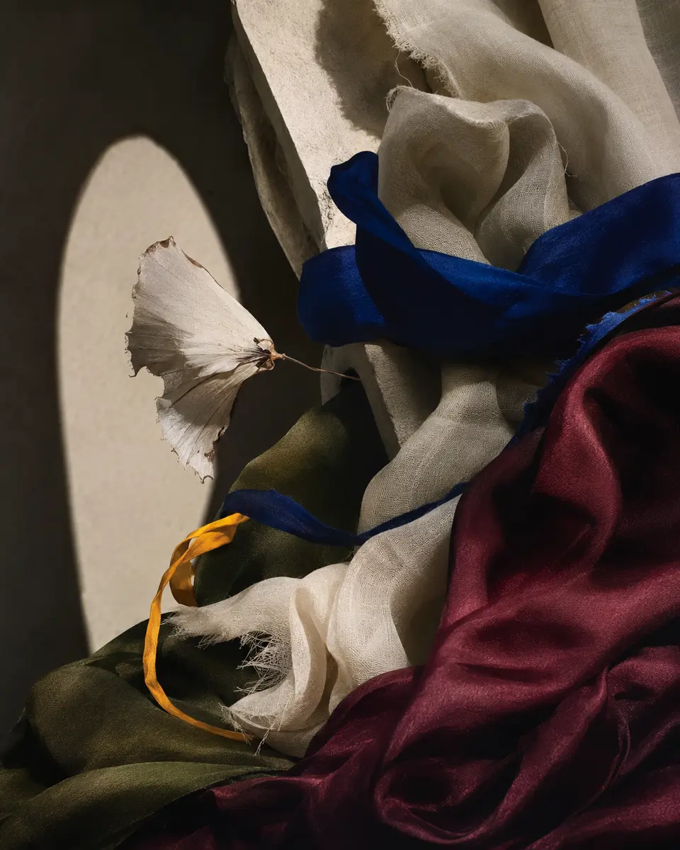 Editorial study of natural textiles in deep blue, burgundy, olive and white